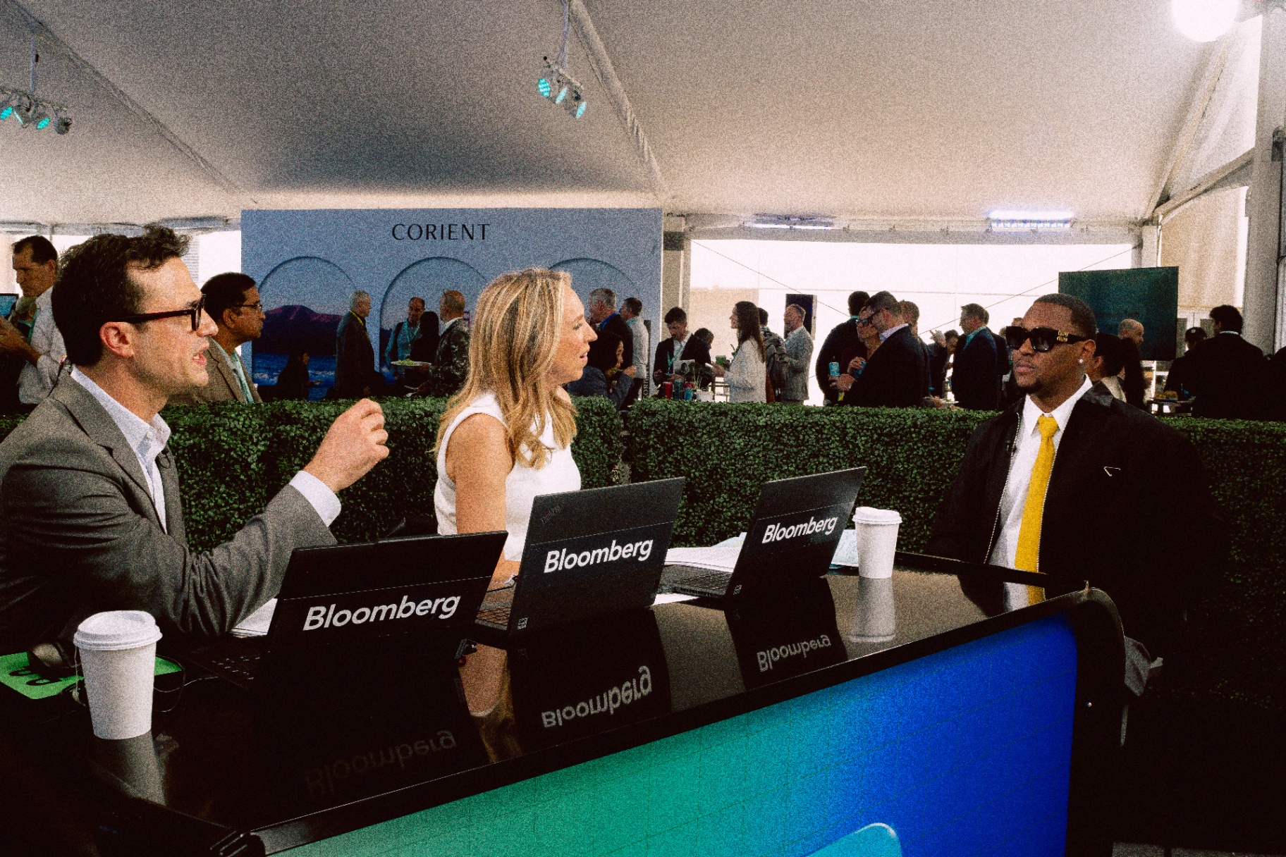 Hit-Boy being interviewed at the Bloomberg desk during Bloomberg Tech 2026, with two Bloomberg anchors on the panel